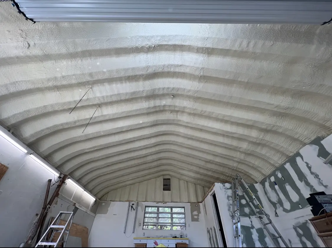 Spray polyurethane foam applied to the underside of a metal roof deck in Nashua